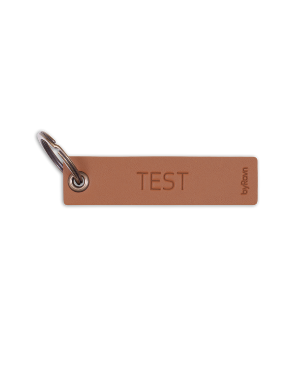 MERRY leather place card sample from byRavn in cognac with the engraving "Test" and metal key ring