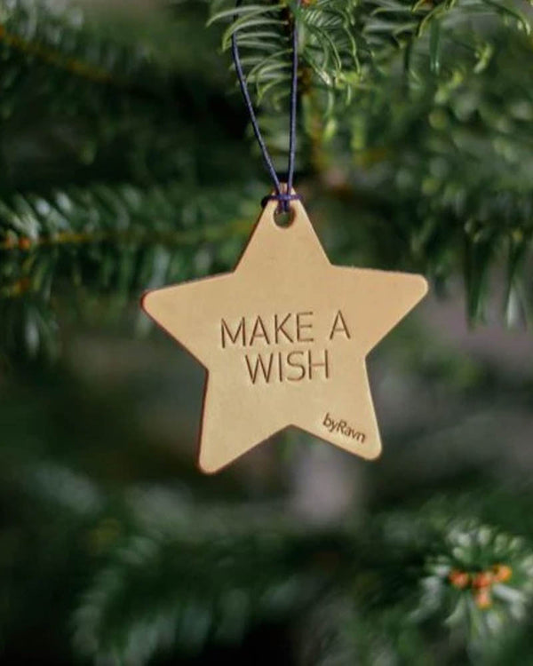 NORTH Christmas star in natural leather with the engraving "Make a wish" hanging in the Christmas tree
