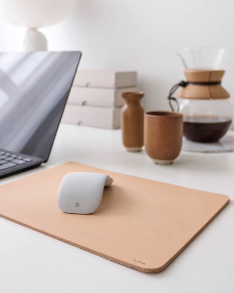 DOS mouse pad in natural full-grain leather on a desk with laptop, mouse, coffee pot and ceramic cup