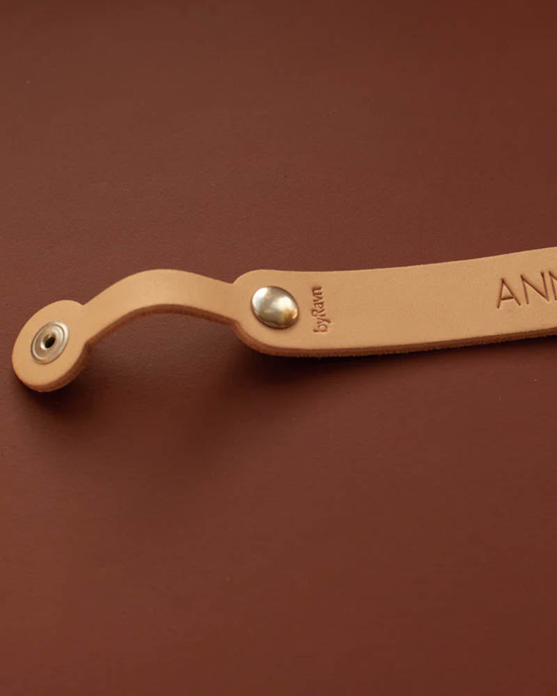 KODA dummy clip in natural leather with metal press stud and byRavn embossing, personalised engraving partly visible on brown