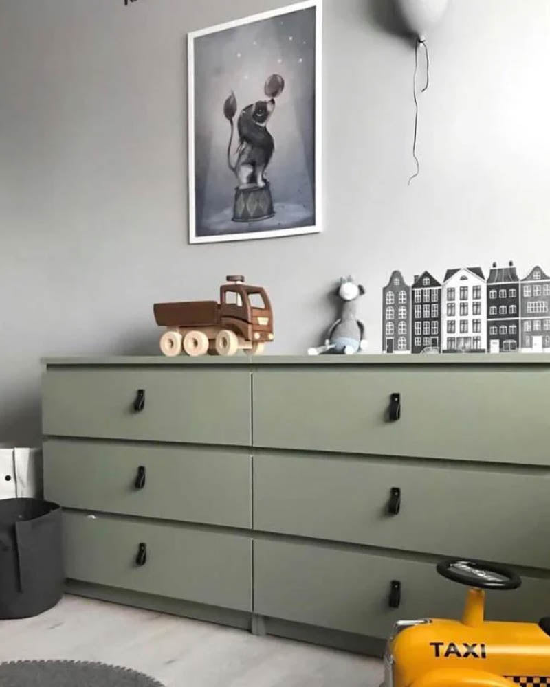 LOOP leather drawer pulls in black on a green chest of drawers in a kids' room with wooden truck, bunnies and yellow taxi ride-on