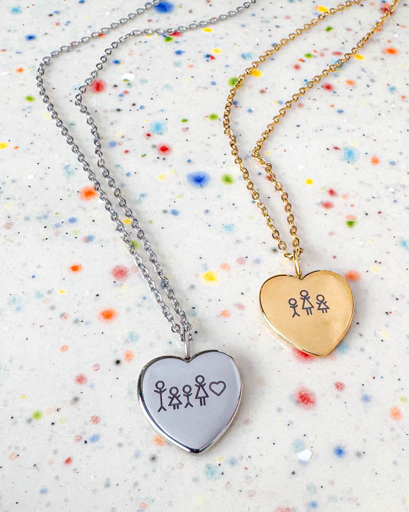LUV STICK necklace in silver-coloured and in gold-plated stainless steel engraved with matchstick family and heart, on speckled ceramic