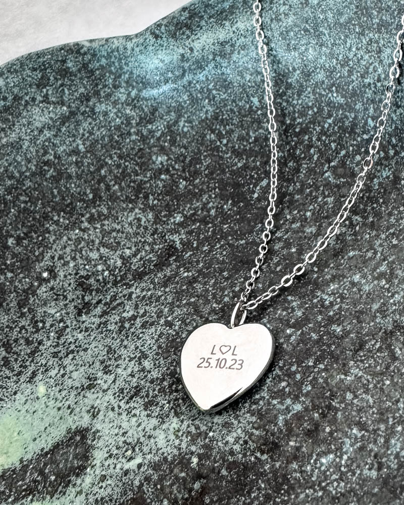 LUV QUOTE necklace in silver-coloured stainless steel with personalised engraving "L ♡ L 25.10.23" on heart pendant, on green patina stone