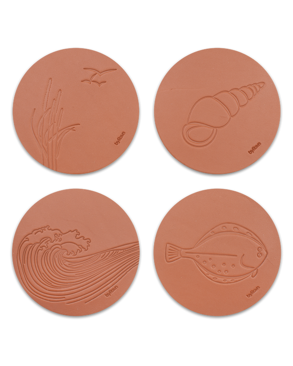 MOKKA summer house leather coasters from byRavn in cognac, set of 4 motifs: marram grass with seagulls, conch shell, wave and flatfish