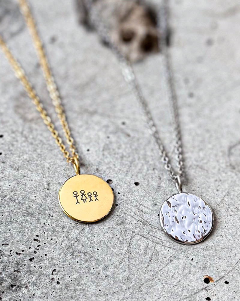 MOON STICK necklace with hammered coin in silver-coloured stainless steel, with gold-plated coin engraved with matchstick family on concrete