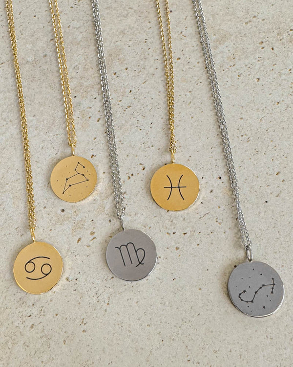 SIA STAR necklaces in gold-plated and silver-coloured steel with Cancer, Pisces and Virgo zodiac signs and constellations, on light stone